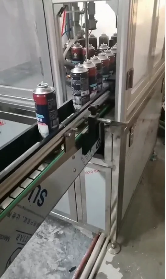 Aerosol cans moving through a filling line