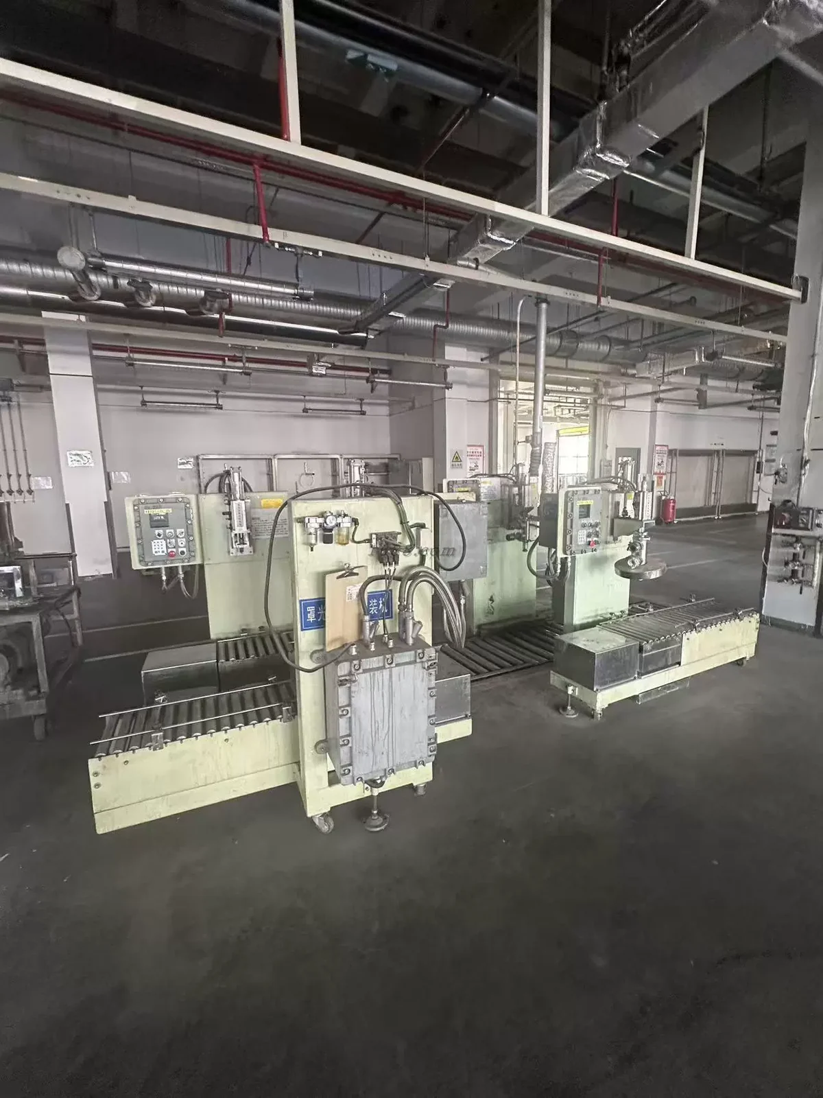 Production machinery beneath overhead pipework