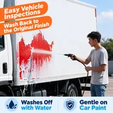 Temporary coating being rinsed from a truck side panel