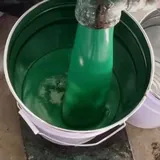 Green coating being lifted from a pail