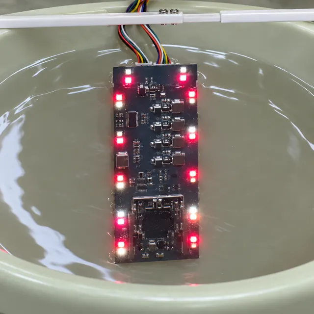 Illuminated circuit board submerged in a tray