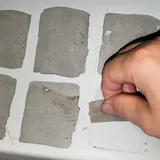 Protective coating being lifted from rectangular test patches