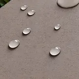 Water beads on a textured stone surface