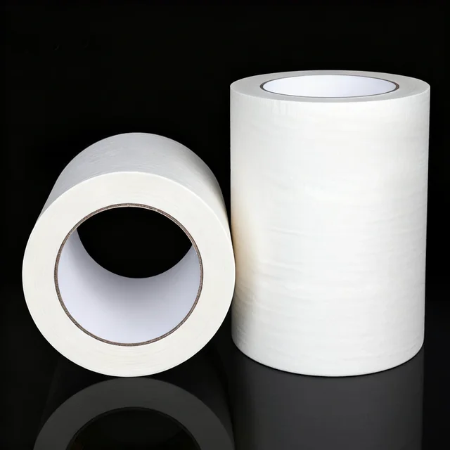 Two upright rolls of extra-wide off-white masking tape