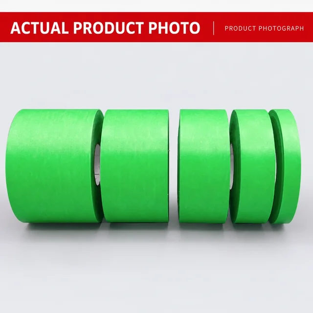 Green low-tack masking tape rolls photographed on a work surface