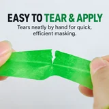 Low-tack paper masking tape being torn by hand